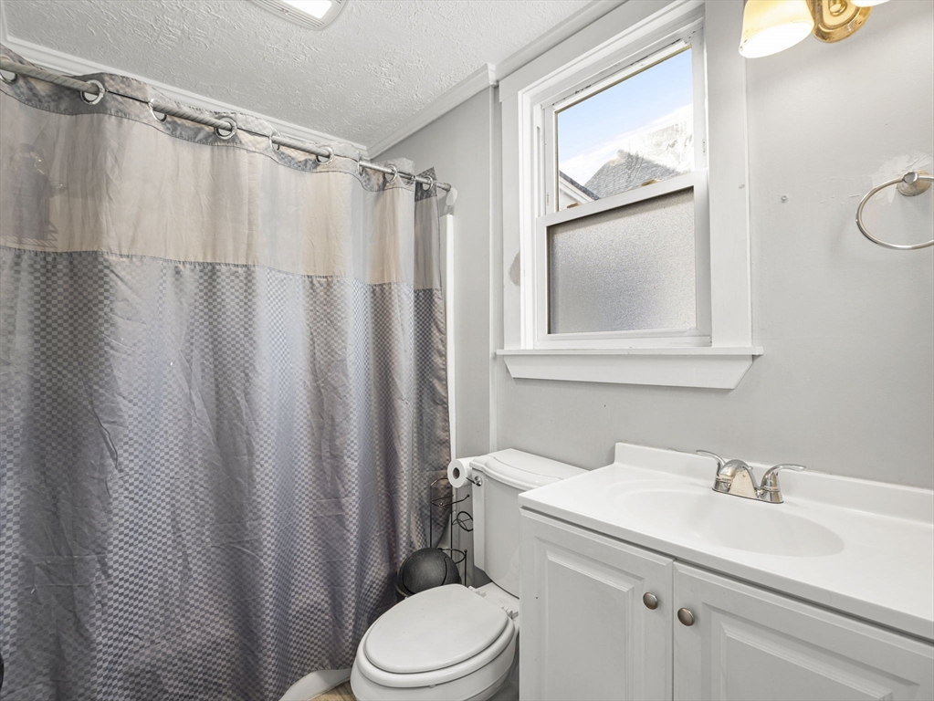 95 South Highland Street Lowell, MA 01852 - Photo 20 of 41 a bathroom with a sink a toilet and a mirror