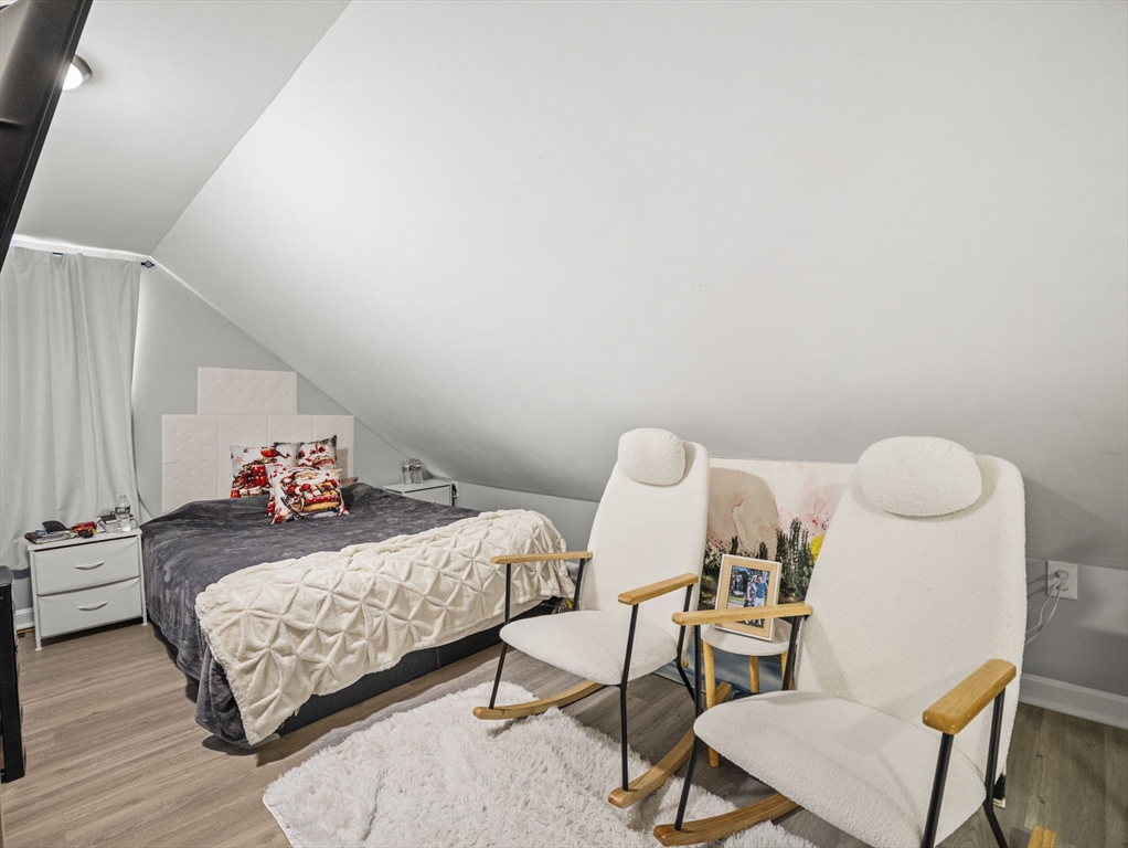 95 South Highland Street Lowell, MA 01852 - Photo 22 of 41 a bedroom with a bed and wooden floor