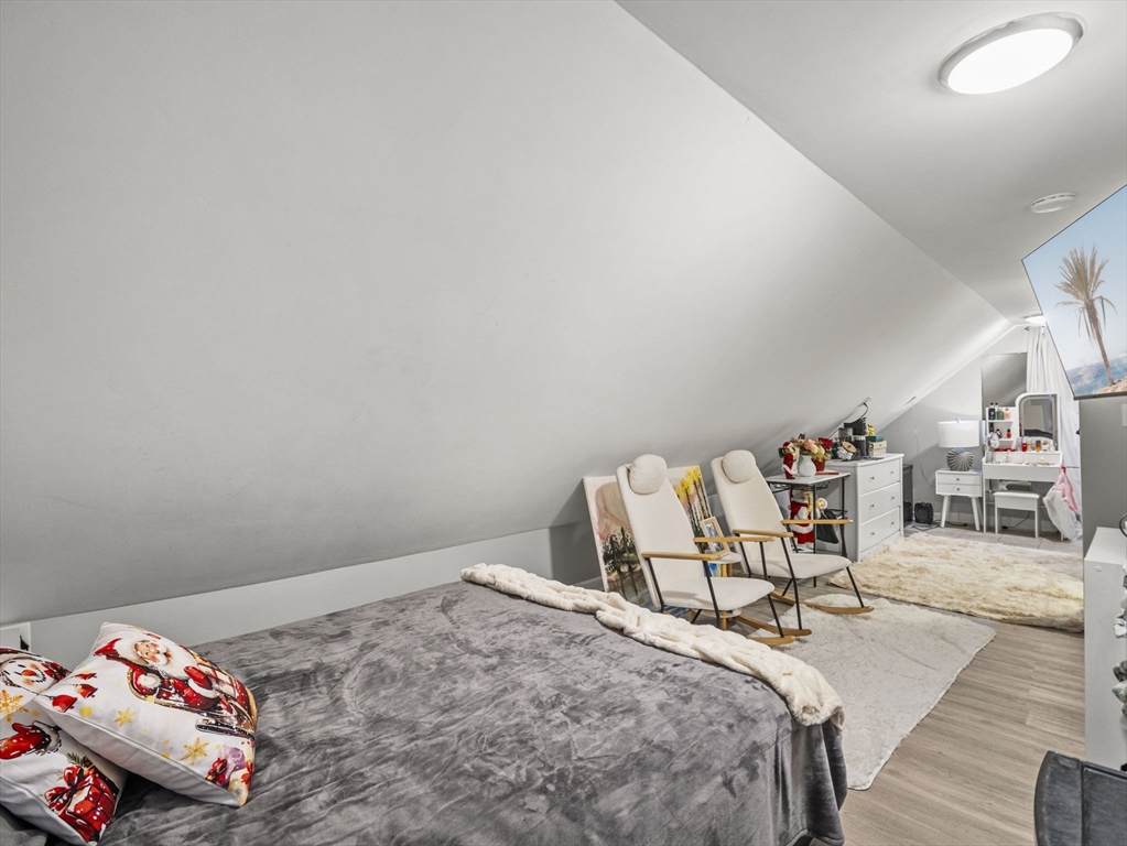 95 South Highland Street Lowell, MA 01852 - Photo 23 of 41 a bedroom with a bed and a table