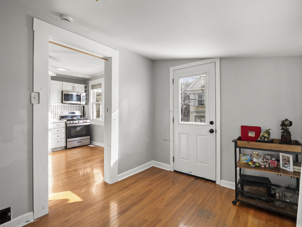 95 South Highland Street Lowell, MA 01852 - Photo 4 of 41 a view of a hallway with wooden floor and a living room