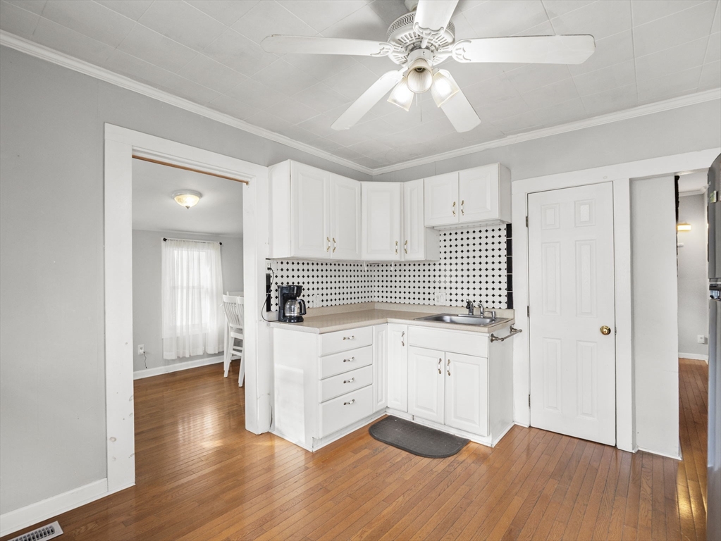 95 South Highland Street Lowell, MA 01852 - Photo 5 of 41 a kitchen with granite countertop white cabinets and white appliances
