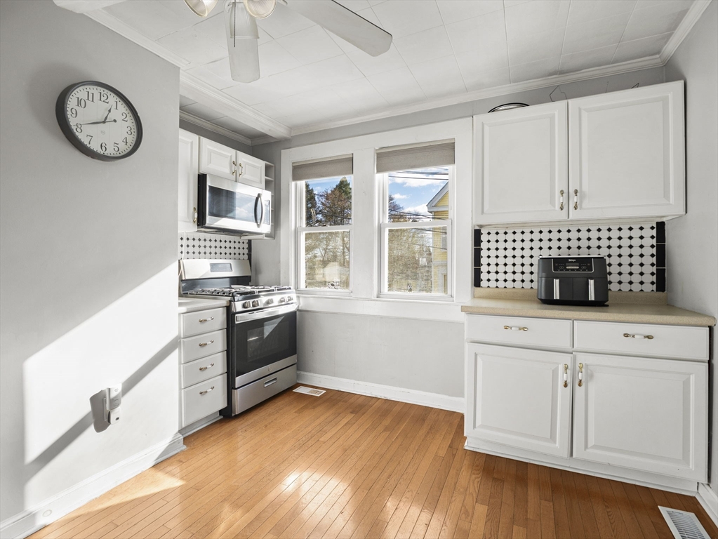 95 South Highland Street Lowell, MA 01852 - Photo 7 of 41 a kitchen with cabinets and window