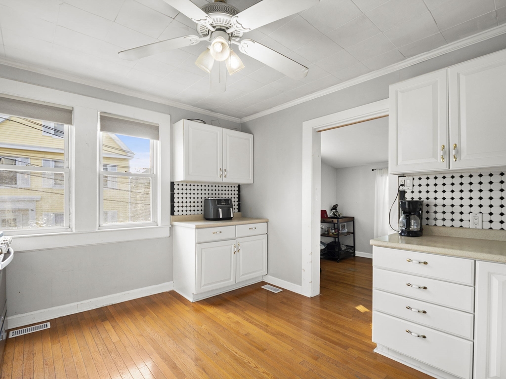 95 South Highland Street Lowell, MA 01852 - Photo 8 of 41 a kitchen with a refrigerator and white cabinets