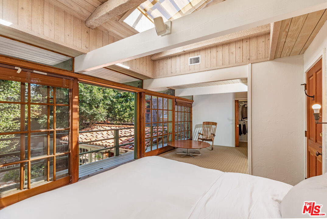 23441 Malibu Colony Road Malibu, CA 90265 - Photo 23 of 43 a bedroom with furniture and large window