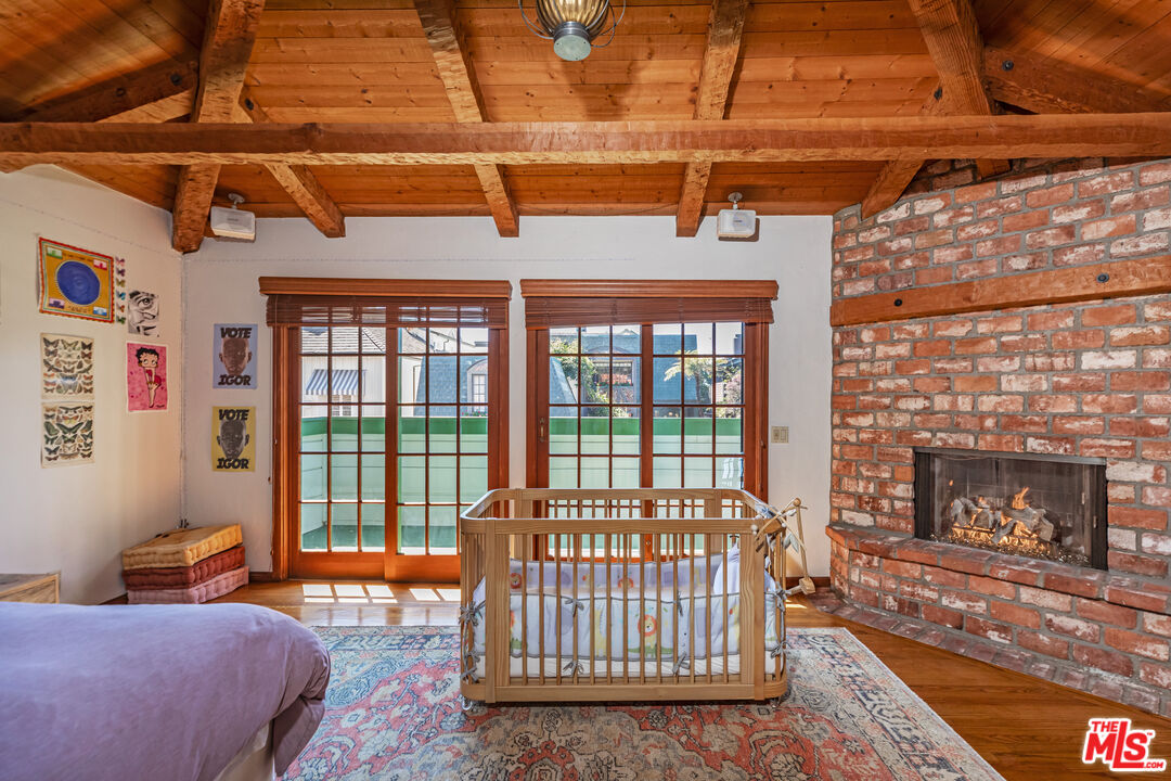 23441 Malibu Colony Road Malibu, CA 90265 - Photo 25 of 43 a living room with furniture a flat screen tv and a floor to ceiling window