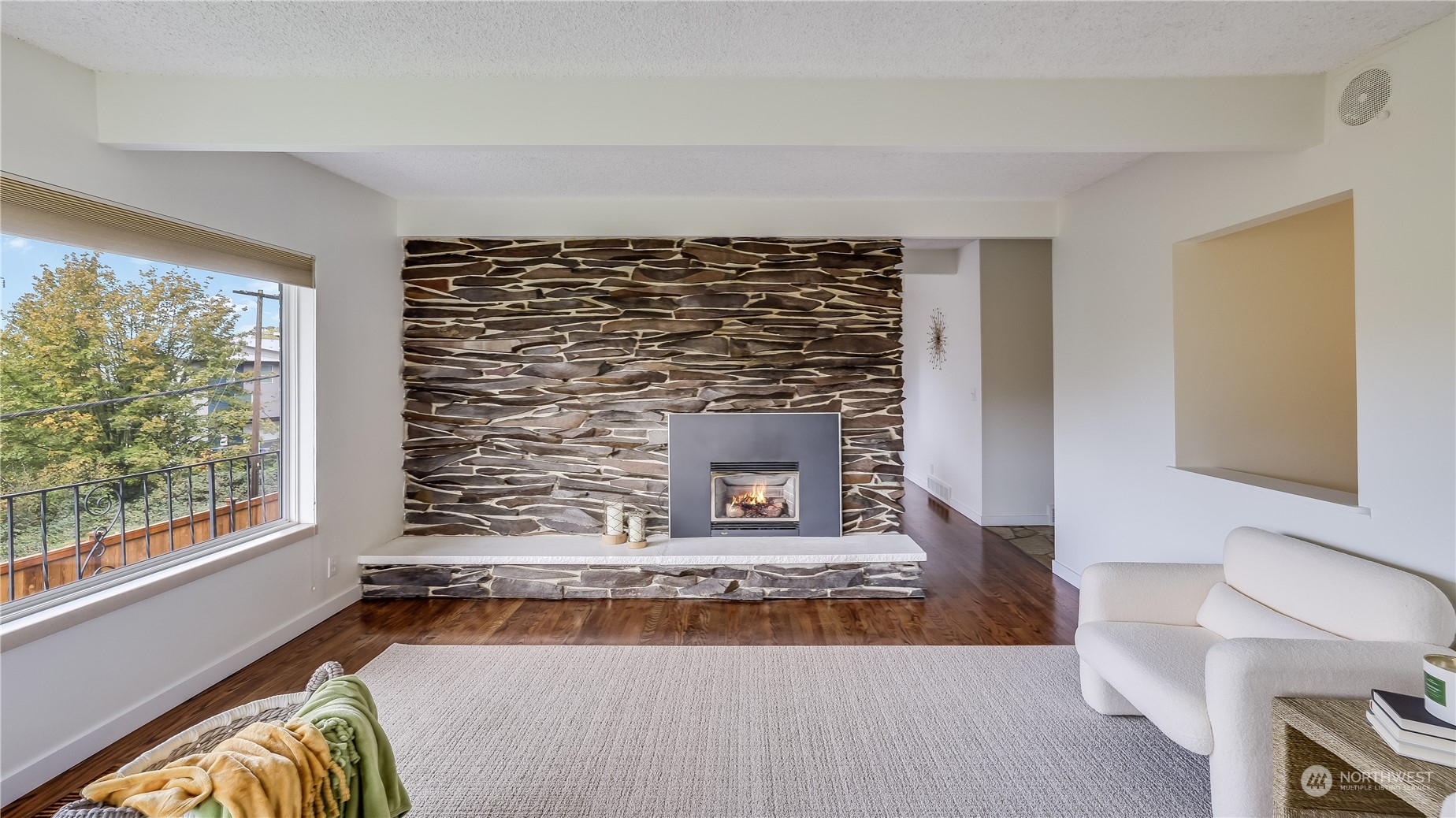 678 Sunset Boulevard Northeast Renton, WA 98056 - Photo 15 of 31 a living room with a rug and a fireplace