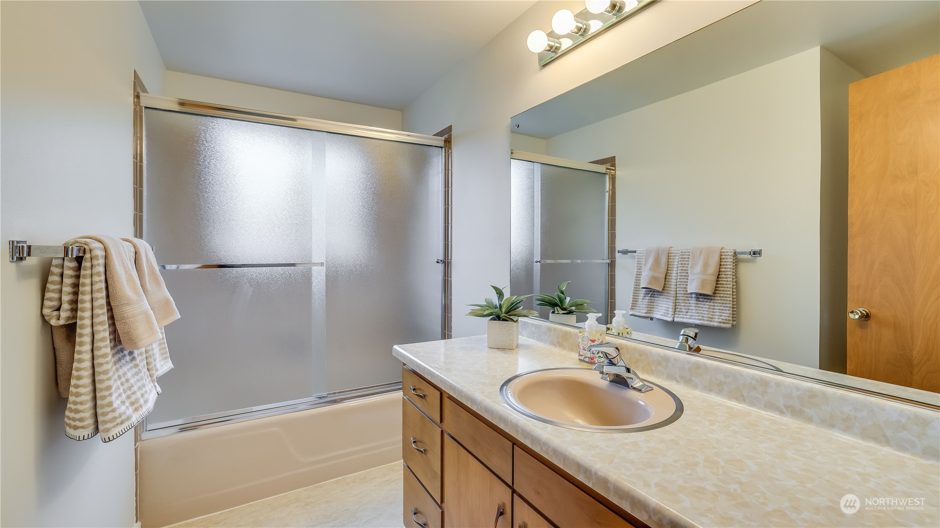 678 Sunset Boulevard Northeast Renton, WA 98056 - Photo 17 of 31 a bathroom with a granite countertop sink and a mirror