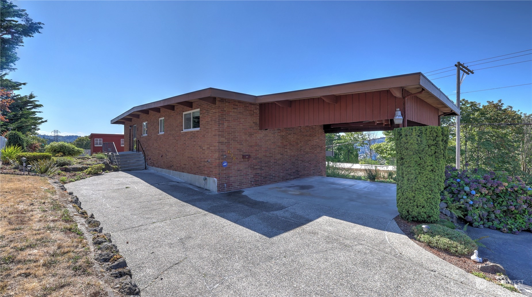 678 Sunset Boulevard Northeast Renton, WA 98056 - Photo 2 of 31 a front view of a house with a yard
