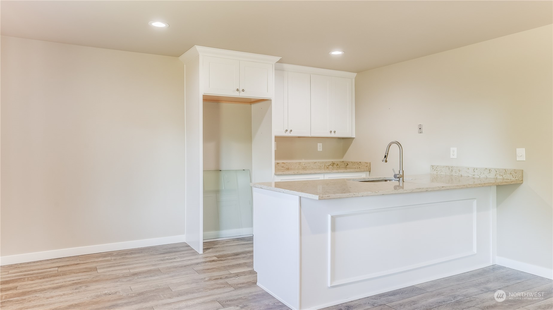 678 Sunset Boulevard Northeast Renton, WA 98056 - Photo 27 of 31 a kitchen with a sink a refrigerator and wooden floor