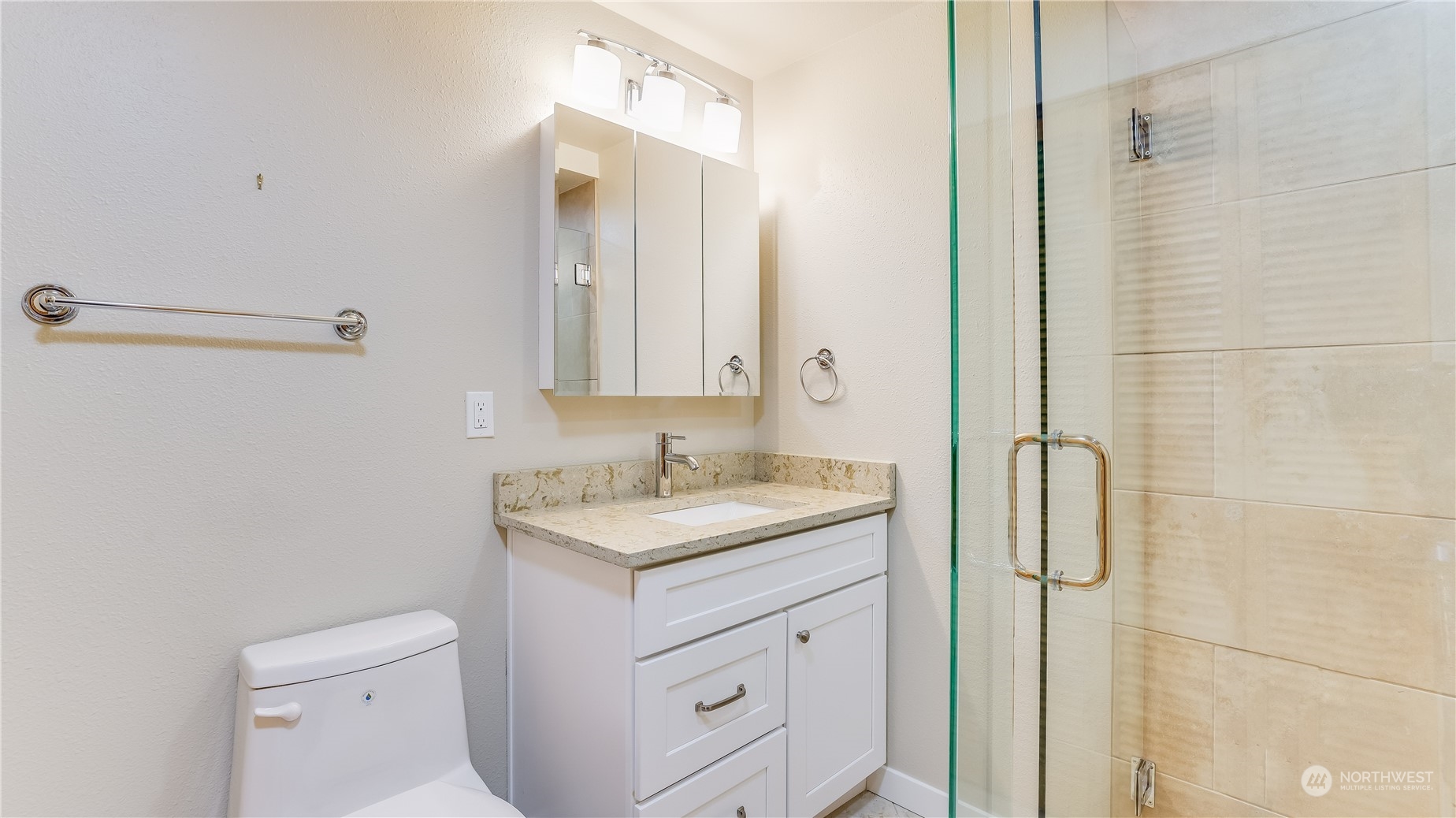 678 Sunset Boulevard Northeast Renton, WA 98056 - Photo 29 of 31 a bathroom with a granite countertop sink toilet and shower