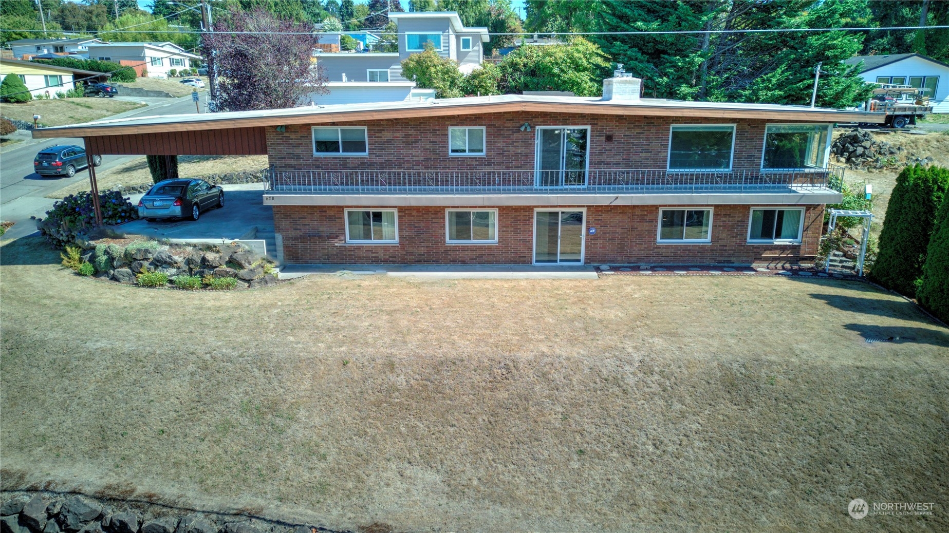 678 Sunset Boulevard Northeast Renton, WA 98056 - Photo 5 of 31 a view of a brick house with a yard