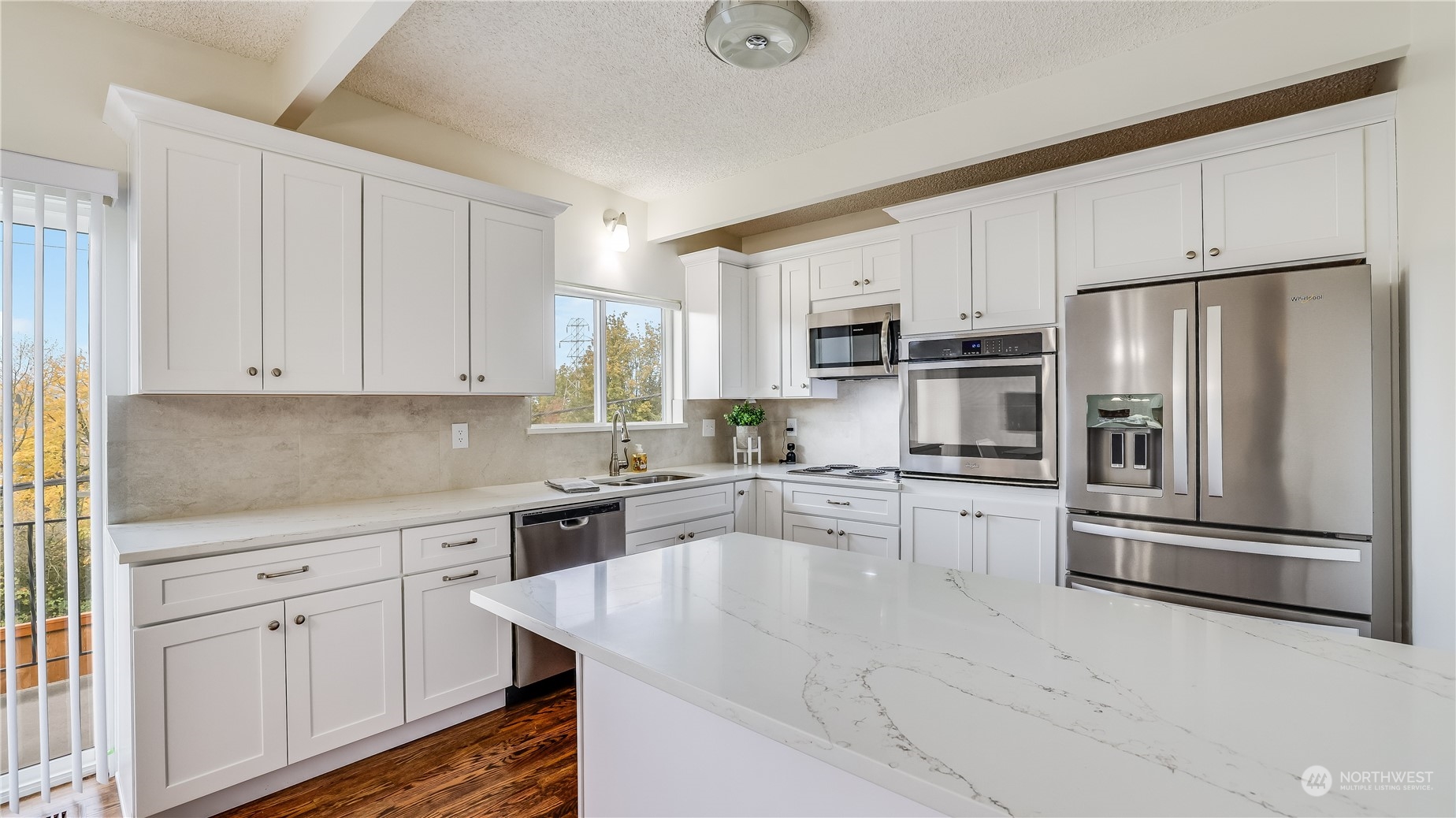 678 Sunset Boulevard Northeast Renton, WA 98056 - Photo 7 of 31 a kitchen with white cabinets and stainless steel appliances