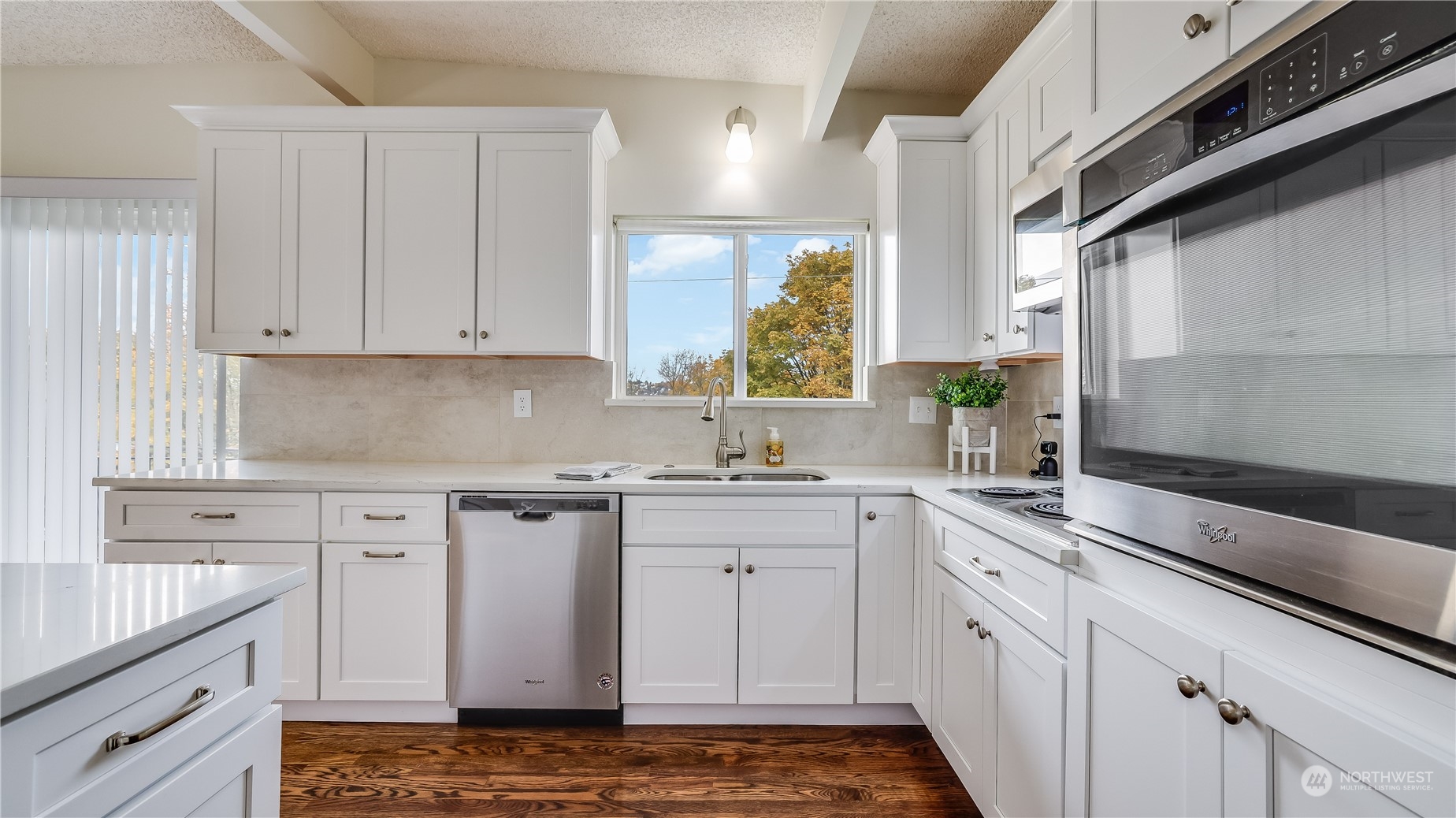 678 Sunset Boulevard Northeast Renton, WA 98056 - Photo 10 of 31 a kitchen with granite countertop white cabinets and white appliances