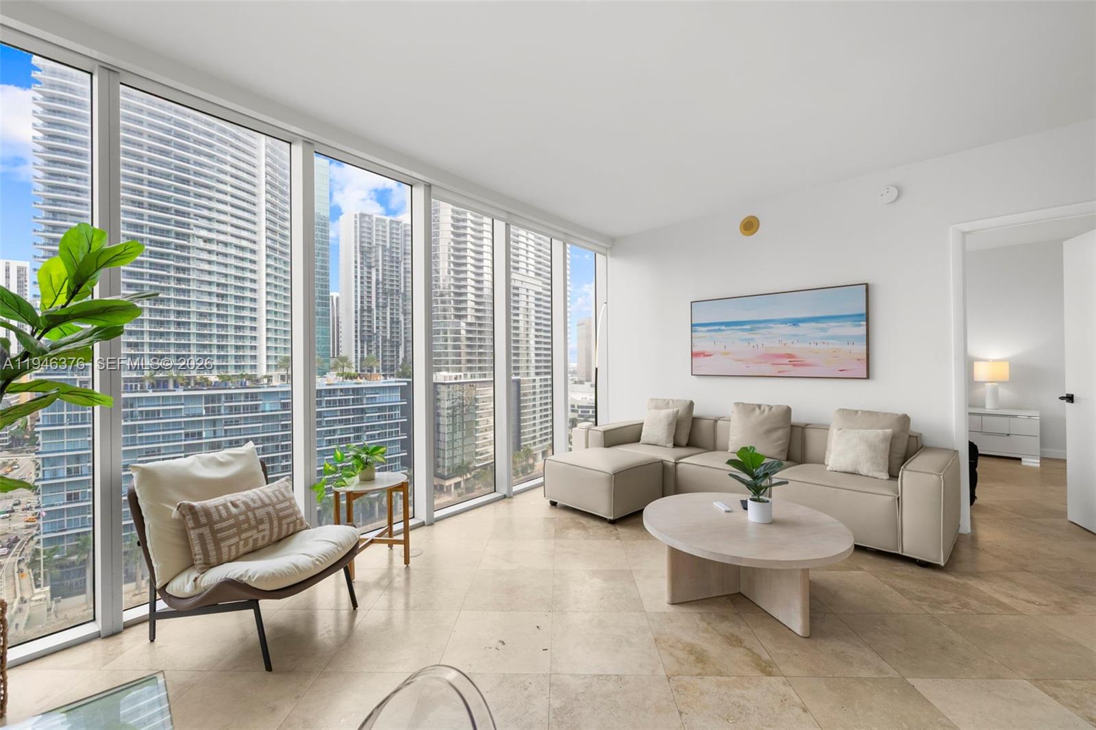 485 Brickell Avenue, Unit 1804 Miami, FL 33131 - Photo 1 of 60 a living room with furniture and a potted plant