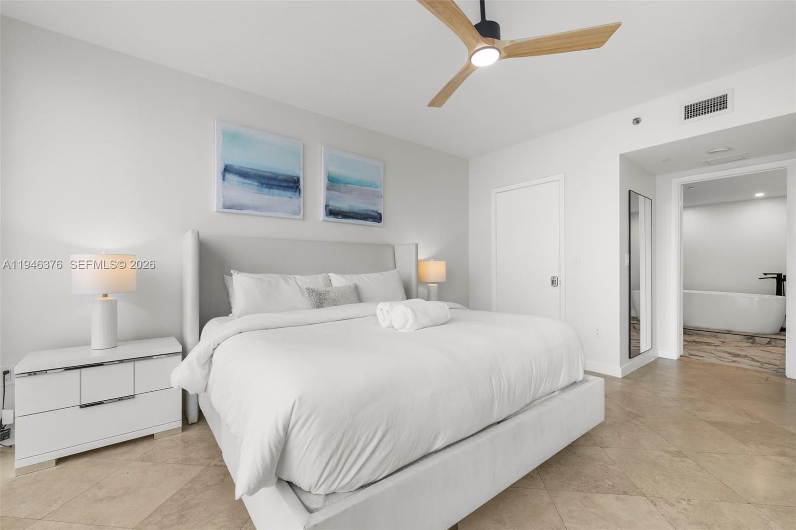 485 Brickell Avenue, Unit 1804 Miami, FL 33131 - Photo 13 of 60 a bedroom with a bed and a cabinets