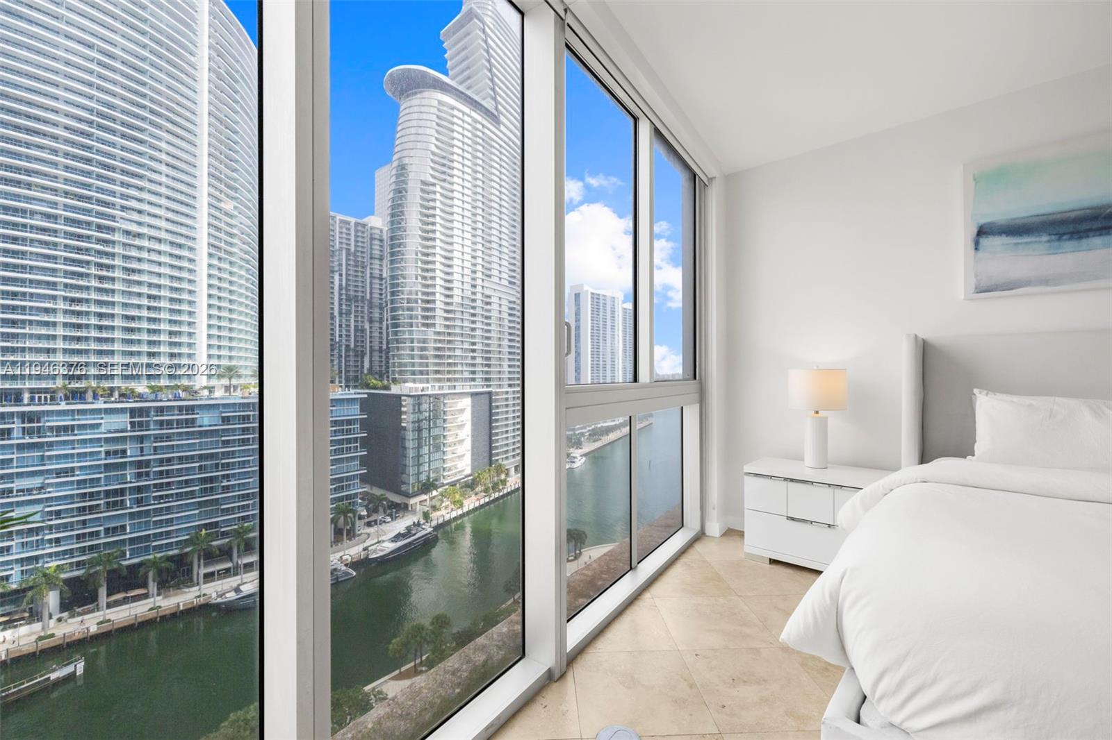 485 Brickell Avenue, Unit 1804 Miami, FL 33131 - Photo 14 of 60 a bedroom with a bed and a window
