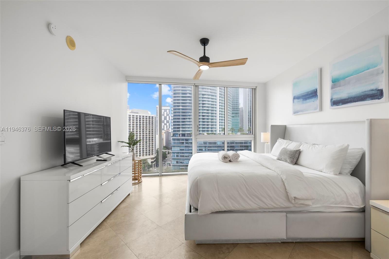 485 Brickell Avenue, Unit 1804 Miami, FL 33131 - Photo 15 of 60 a bedroom with a bed and a flat screen tv