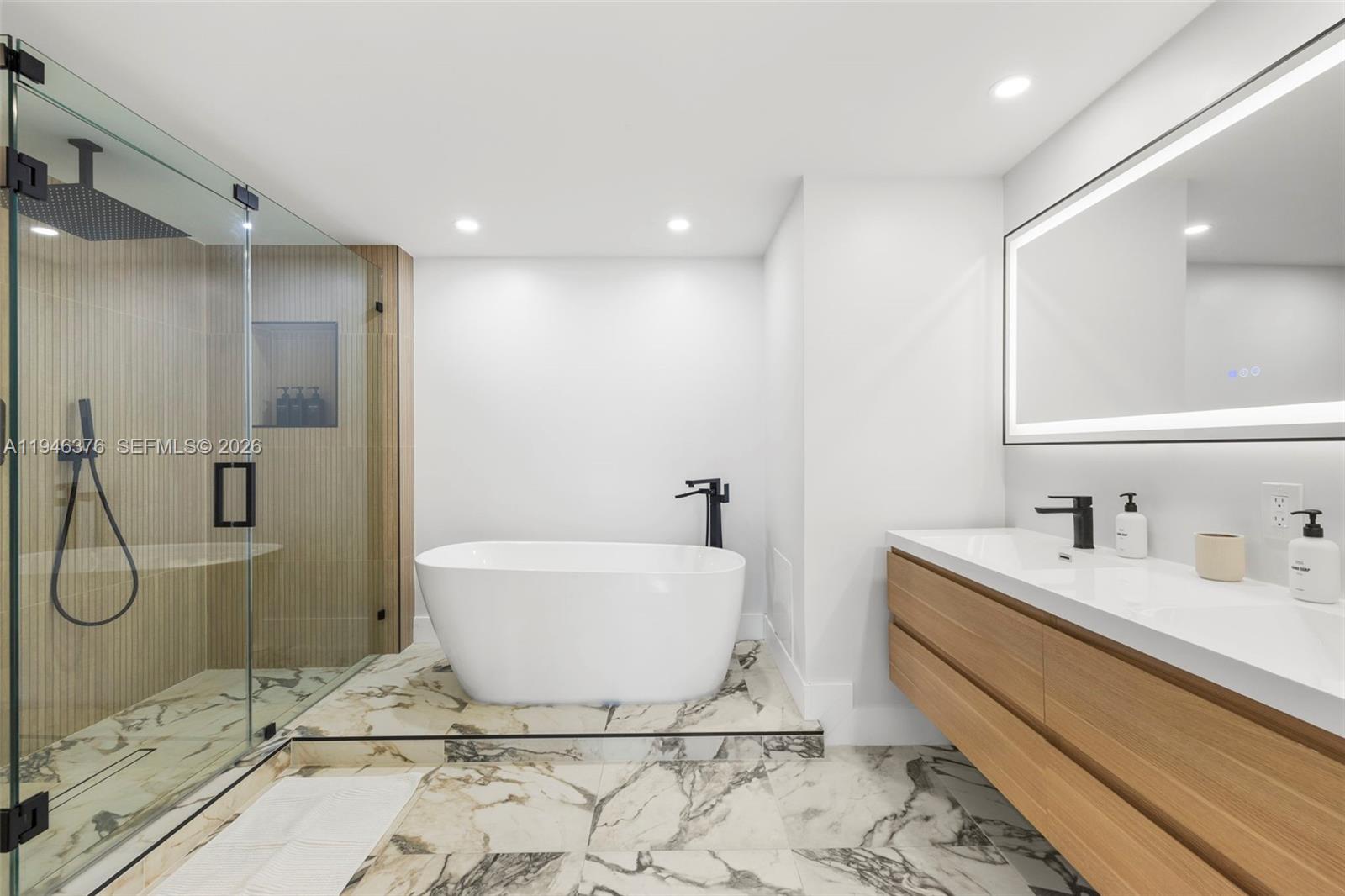 485 Brickell Avenue, Unit 1804 Miami, FL 33131 - Photo 18 of 60 a bathroom with a bathtub and a sink