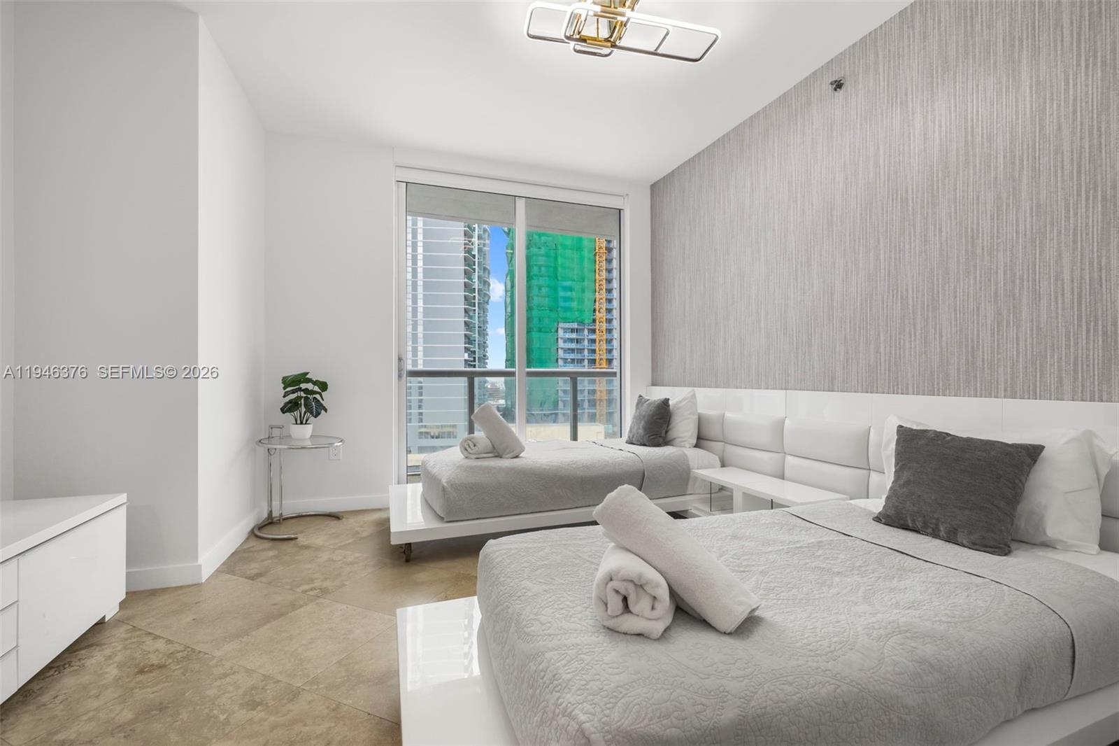 485 Brickell Avenue, Unit 1804 Miami, FL 33131 - Photo 23 of 60 a bedroom with a bed and a couch