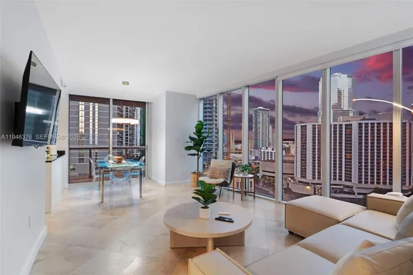 a living room with furniture and large windows