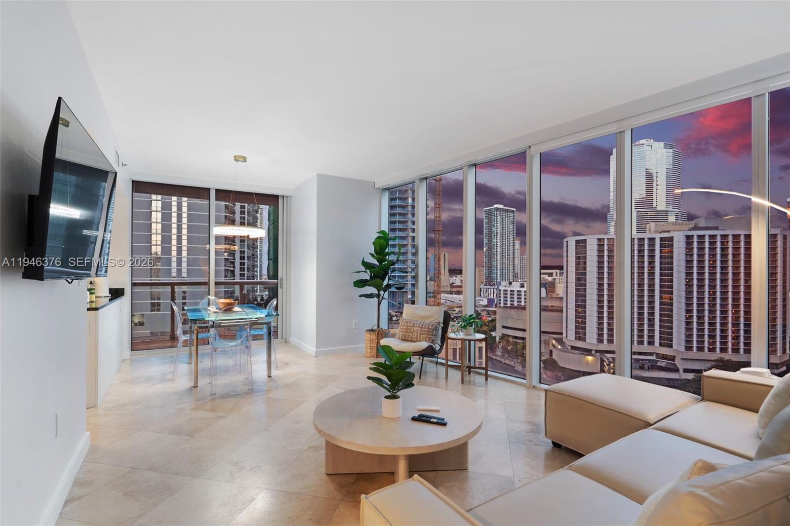 485 Brickell Avenue, Unit 1804 Miami, FL 33131 - Photo 38 of 60 a living room with furniture and a flat screen tv