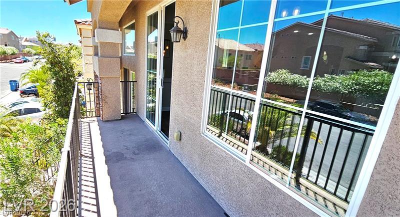 6302 Jackson Spring Road Las Vegas, NV 89118 - Photo 12 of 48 A private balcony offers serene views of the neighborhood, enhancing outdoor living space.
