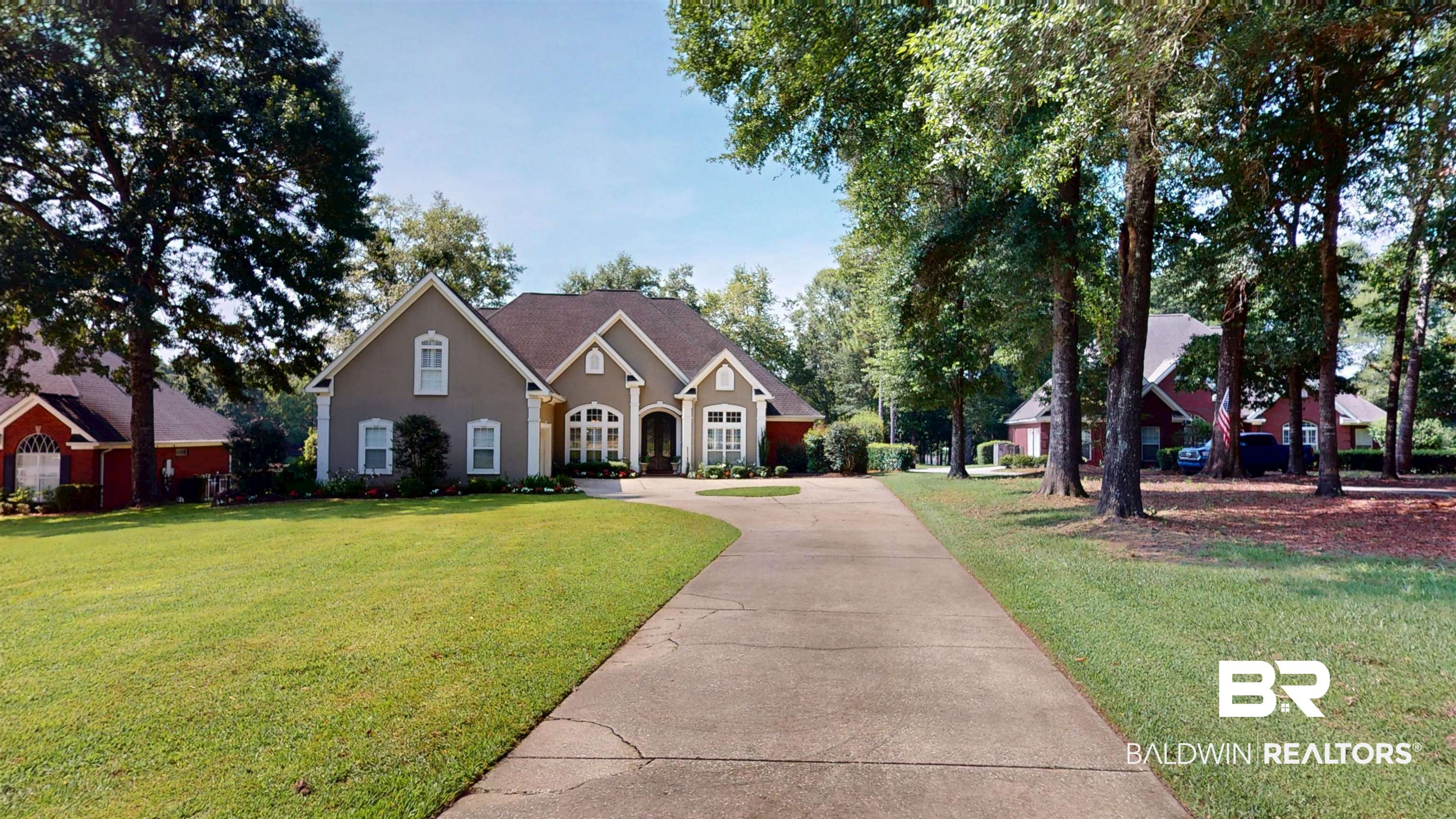 8775 Dawes Lake Road North Mobile, AL 36619 - Photo 3 of 59 View of front of property featuring driveway, a front lawn, and stucco siding