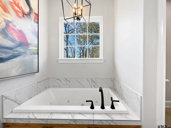 a bathroom with bathtub and window