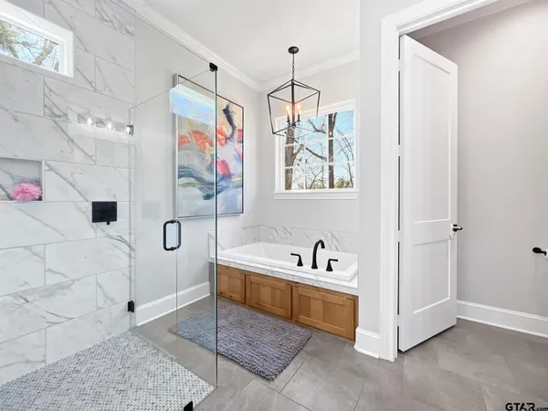 a spacious bathroom with a bathtub and a shower