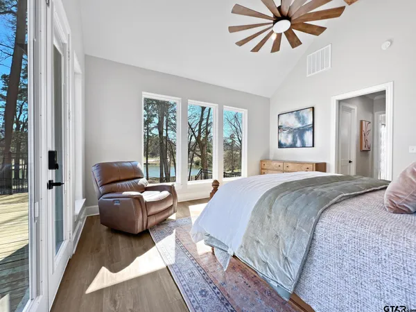 a spacious bedroom with a bed couch and a window