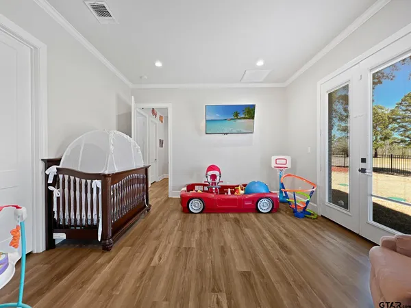 a bedroom with furniture and a wooden floor