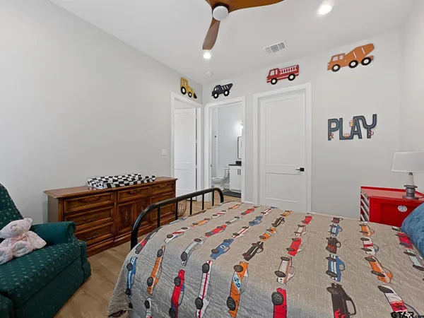 a bedroom with a bed and a dresser