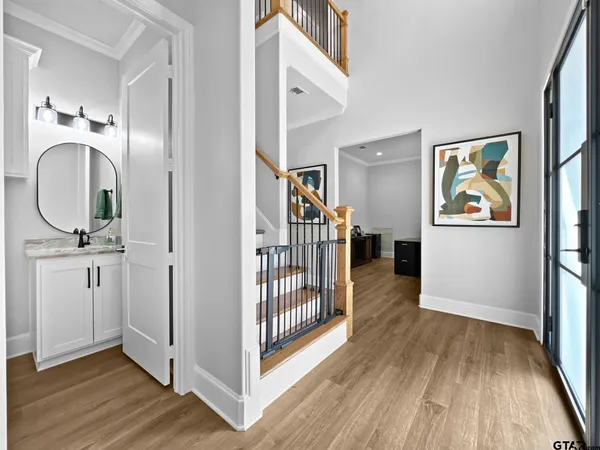 a view of entryway and hall with wooden floor