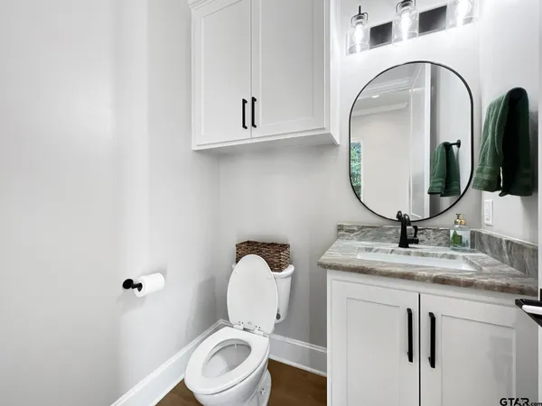 a bathroom with a toilet sink and mirror