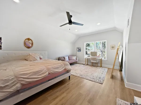 a bedroom with a bed and a large window