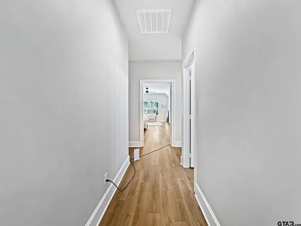a view of a hallway with wooden floor
