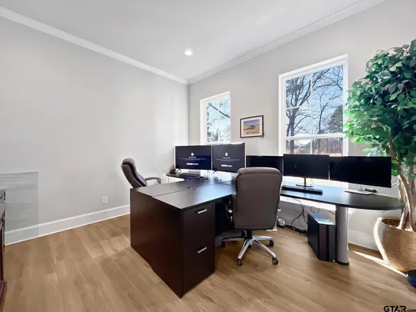 a view of a workspace with furniture and a window