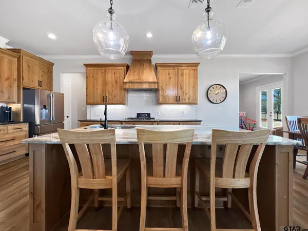 a large kitchen with a dining table and chairs