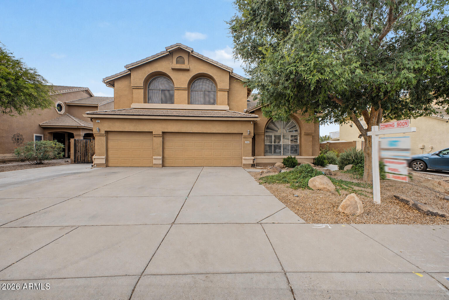 1306 East Erie Street Gilbert, AZ 85295 - Photo 2 of 62 a front view of a house with a yard and garage