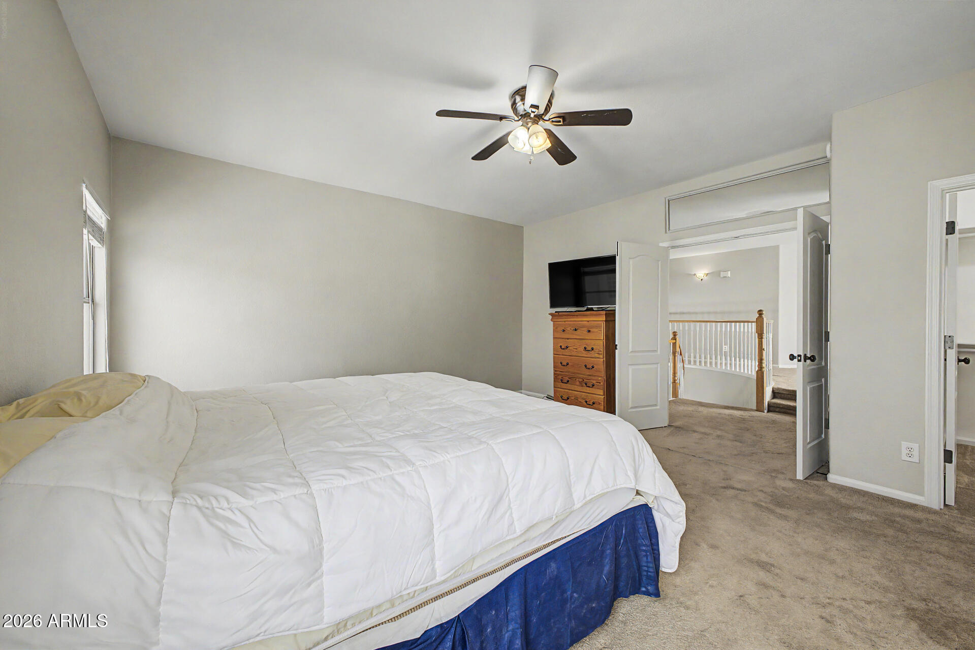 1306 East Erie Street Gilbert, AZ 85295 - Photo 23 of 62 a bedroom with a bed and a chandelier
