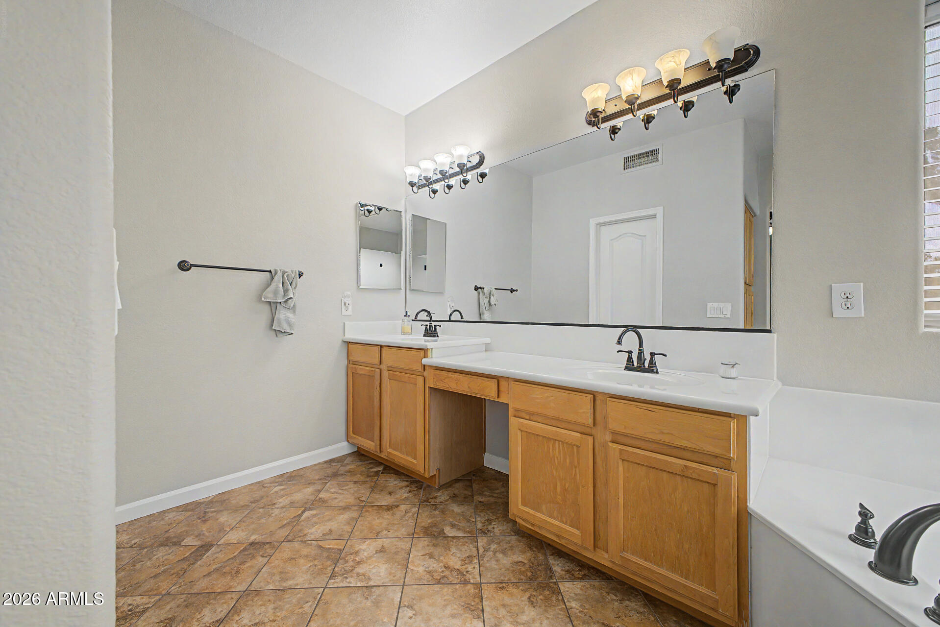 1306 East Erie Street Gilbert, AZ 85295 - Photo 26 of 62 a bathroom with a sink and a mirror