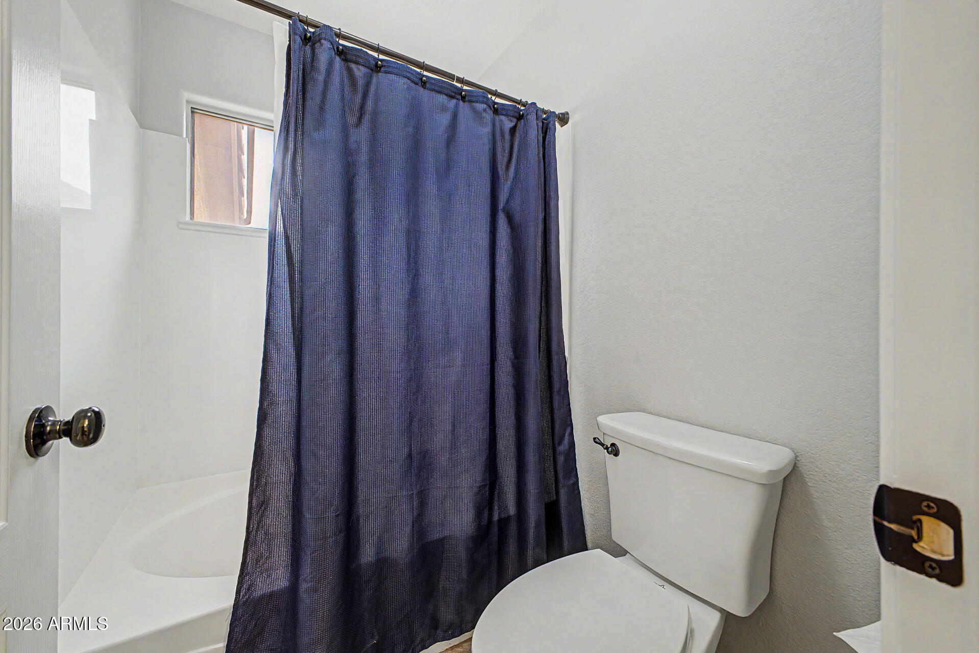1306 East Erie Street Gilbert, AZ 85295 - Photo 32 of 62 a white toilet sitting next to a wooden cabinet