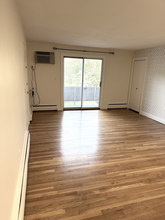 25 Lionel Avenue, Unit E Waltham, MA 02452 - Photo 9 of 13 a view of a room with wooden floor and window