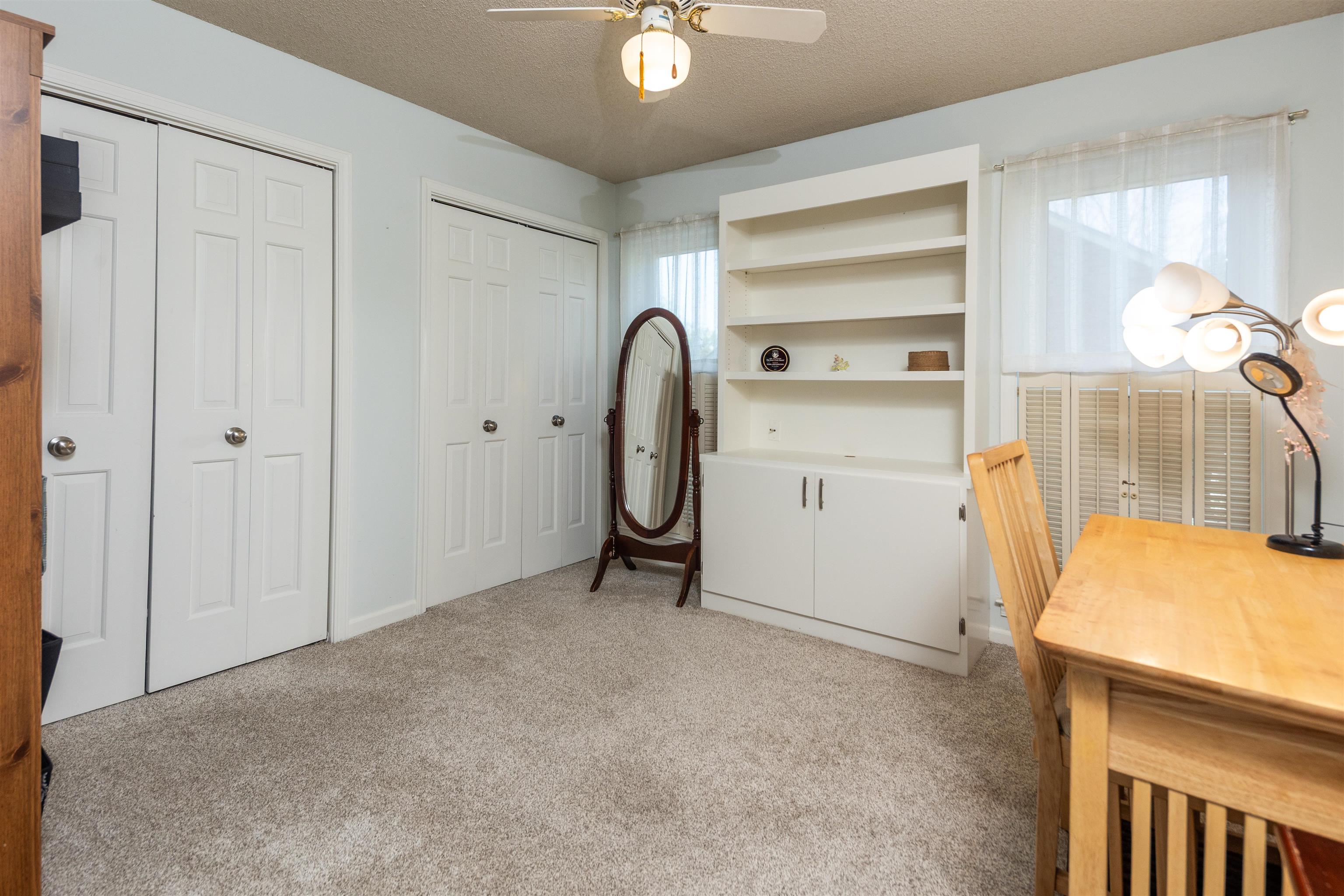 6917 Amberly Road, Unit 6917 Memphis, TN 38119 - Photo 17 of 35 Laundry area featuring ceiling fan, light carpet, and a textured ceiling