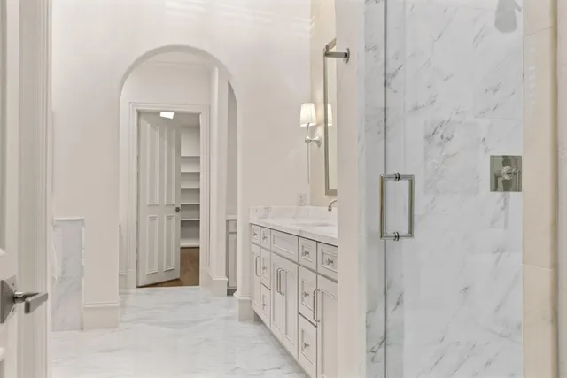 a spacious bathroom with a granite countertop sink mirror and a bathtub