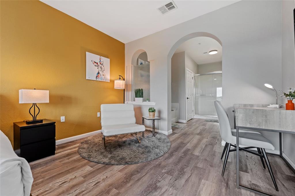 14200 Avalon Road, Unit 409 Winter Garden, FL 34787 - Photo 17 of 33 a living room with furniture and wooden floor