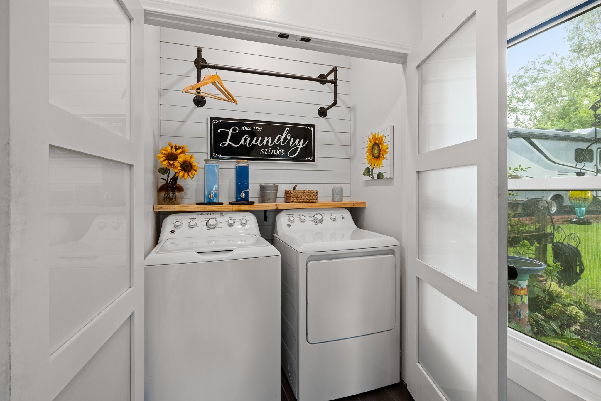 34310 High Point Drive Magnolia, TX 77355 - Photo 30 of 48 This cozy laundry room features a perfect place for your washer and dryer, decorative shelving, and an accent wall. The space is bright and functional, with charming accents like a hanging rod for a welcoming touch