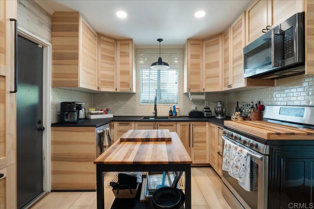 646 Downer Avenue El Cajon, CA 92020 - Photo 1 of 18 a kitchen with stainless steel appliances granite countertop a sink a stove and cabinets