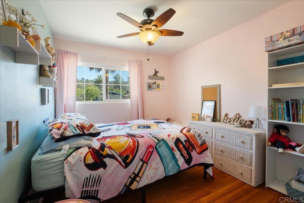 646 Downer Avenue El Cajon, CA 92020 - Photo 11 of 18 a bedroom with a bed and a chandelier