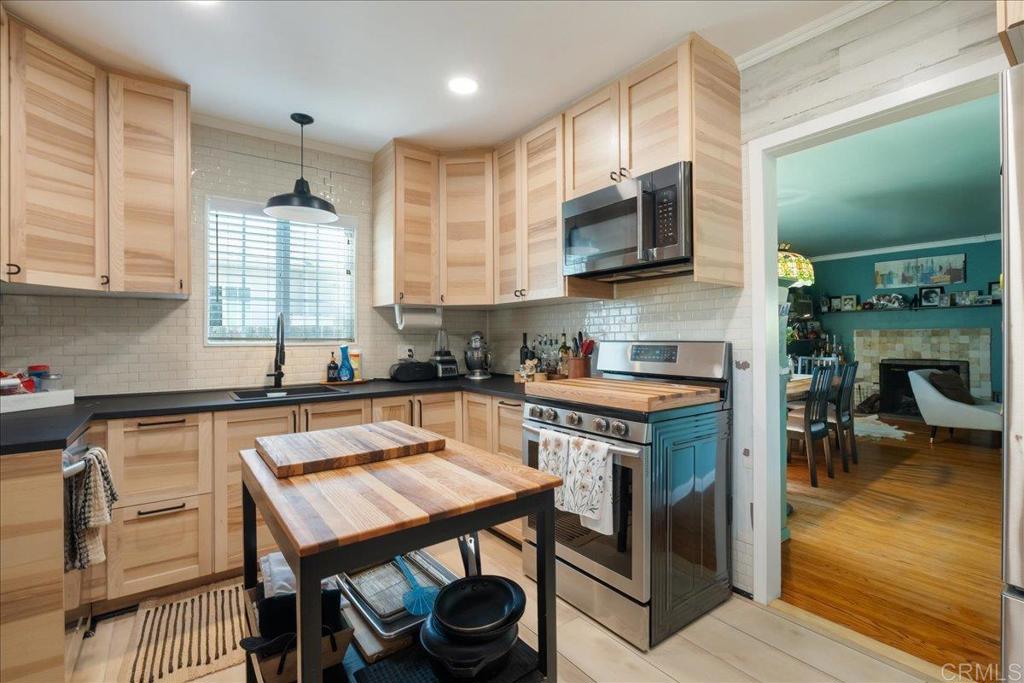646 Downer Avenue El Cajon, CA 92020 - Photo 3 of 18 a kitchen with a stove a sink and a microwave